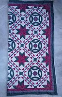 Full view of folded quilt showing overall pattern and border