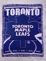 Full view of blanket showing graphic design and fringe