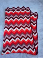 Folded afghan showing full chevron stripe pattern and scalloped edge