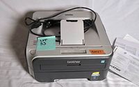 Front and top view of Brother laser printer with power cord
