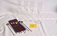 Full lot showing 4 flutes, 8 spoons, pouch