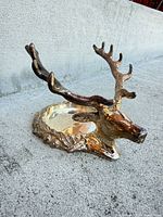 Single deer head candle holder showing gold-tone plated finish and candle recess