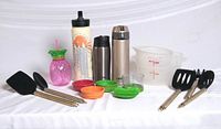 Group shot showing all kitchen utensils, bottles, spiralizer parts, measuring pitchers