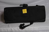 Front of closed black saxophone case showing handle and strap