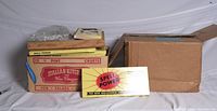 Stack of Spell Power game boxes in carton beside additional carton