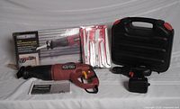 Overall lot showing saw, blade pack, drill, case, battery/charger