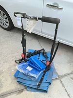 Bike rack atop stacked blue tarps beside vehicle