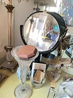 Group view showing vase, mirror, lamp base and small decor items