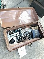 Overview of open brown toolbox with assorted tools inside