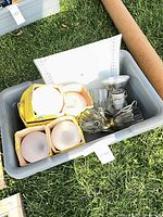 Tub containing boxed glass globes, diffuser panel, brass light fixture and bulb