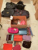 Group shot of entire lot showing large bags, box of small purses, wallets and accessories