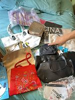 All eight bags laid out on bed