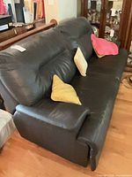 Side view of black leather 3-seater sofa