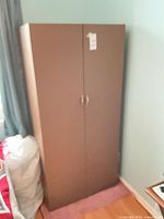 Front view of brown metal wardrobe with double doors