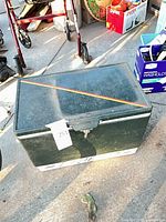 Closed green Coleman cooler showing overall exterior