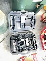 Router, cord and accessories inside open case