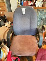 Front view of office chair showing fabric backrest, seat, arms