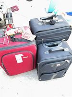Group shot of three suitcases showing colors, sizes, handles