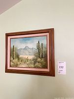 Full view of framed desert landscape painting on wall