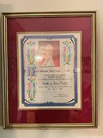 Full view of framed certificate under glass