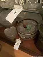 shelf with heart box, ribbed bowls, small colored glasses