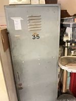 Full front view of gray metal locker numbered 35