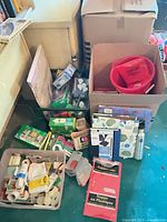 Overview of lot showing boxes, notebooks, water bottle, tablecovers, bucket and tote