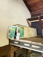 Torn cardboard box containing Jackson Spruce 4.5-ft pre-lit tree