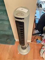 Full view of Lasko tower fan standing on floor