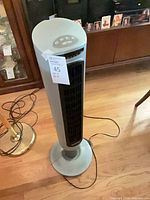 Full view of the Lasko tower fan standing on base with power cord visible