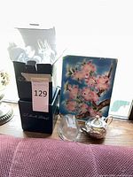 Overall lot showing two L.E. Smith boxes, painted tile, glass rabbit, silver teapot