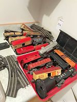 Overview of locomotives, freight cars, passenger cars and track in trays