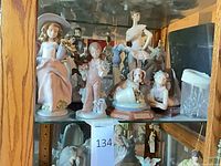 Cabinet shelf showing multiple Lladró figurines