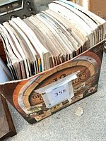 Box filled with stacked magazines, front view