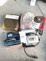 Group shot showing both sanders, abrasive rolls, Scotch-Brite pack
