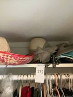 Shelf view showing sombrero, sun hat, visors, cap