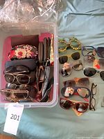 Overview of bin of eyewear and additional pairs laid out