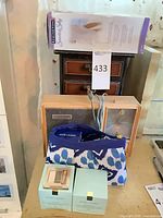 Lot overview showing Remington box, creams, cosmetic bag and vintage radio