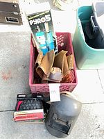 Grouped view showing boxed Pyro5 torch, leather tool belt in crate, knee pads box, welding helmet and hose