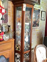 Full view of curio cabinet showing glass panels and contents