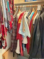 Closet rod with shirts, jerseys, leather jacket and ties