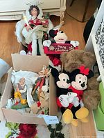 Group shot of plush toys, angel tree topper, box of figurines