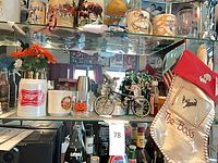 Shelf view showing Miller stein, ceramic mug, and pumpkin glass