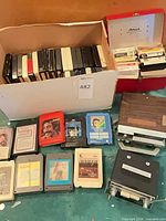 Box of numerous 8-track cartridges and two car players