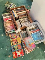 Overall lot showing boxes of mixed DVDs, CDs, VHS and Blu-ray