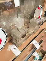 pair of glass decanters with stoppers in metal carrier