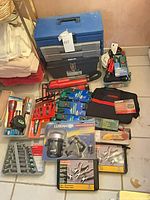 Overall view of toolbox, power strip, hand vac, bit sets, lighting and cords