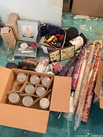 Overview of lot showing carton of tumblers, umbrellas, accessories bag, decorative tiles