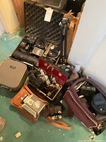 Group shot showing cameras, lenses, tripod and multiple cases