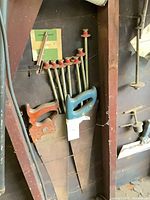 Two panel saws and seven threaded clamp rods visible in wall stud cavity